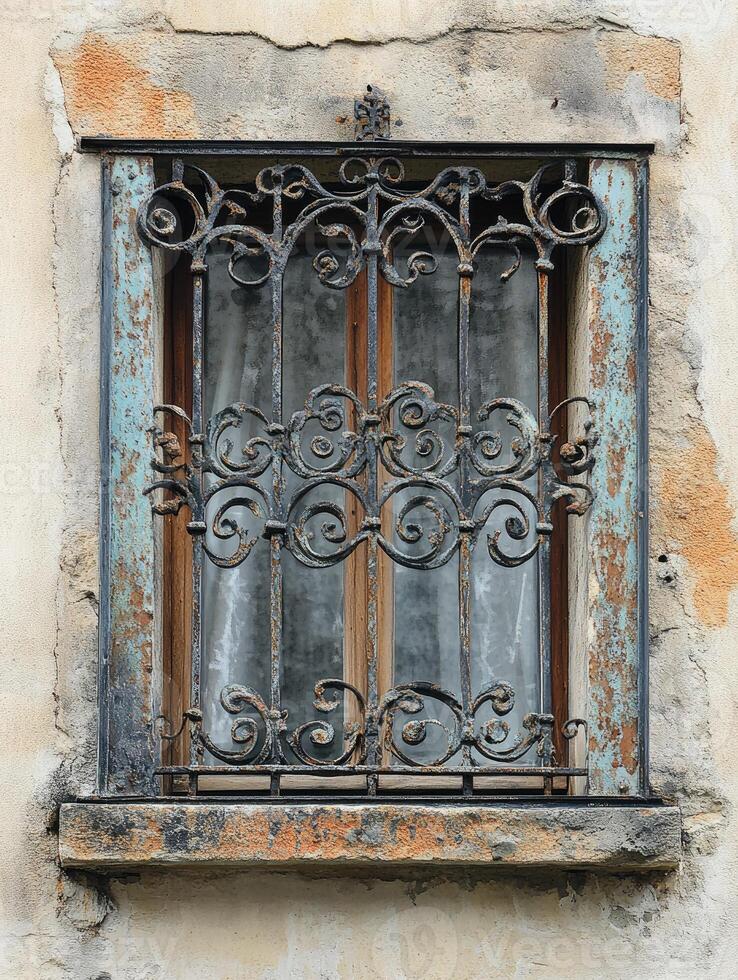 Old window with ornate iron grill showing age and weathering photo