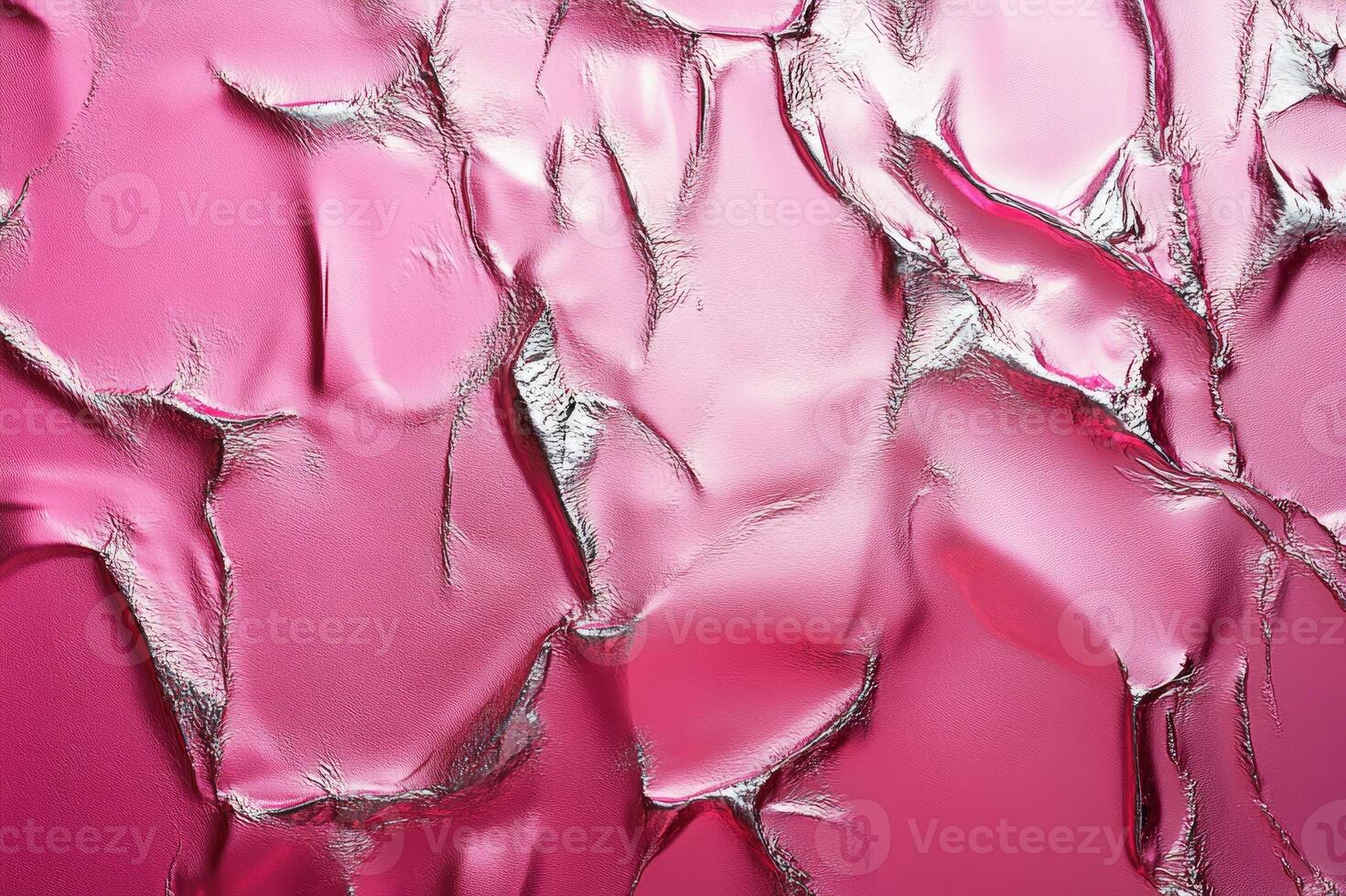 Crumpled pink material reflecting silver light creating abstract pattern photo