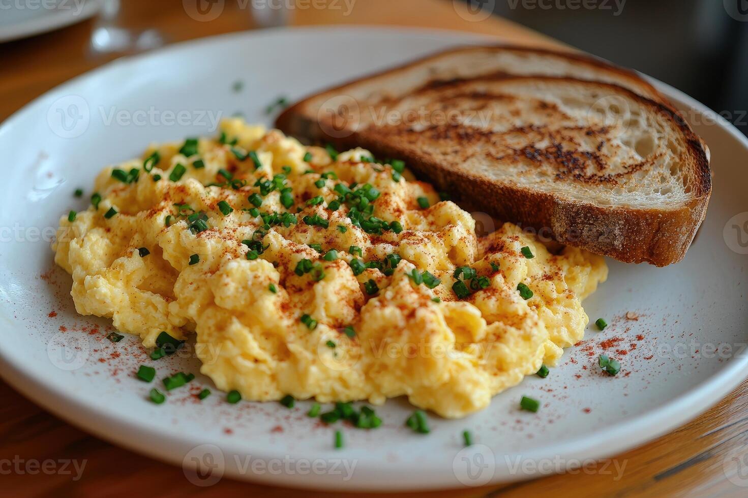 Plate of scrambled eggs with toast and salad for breakfast photo