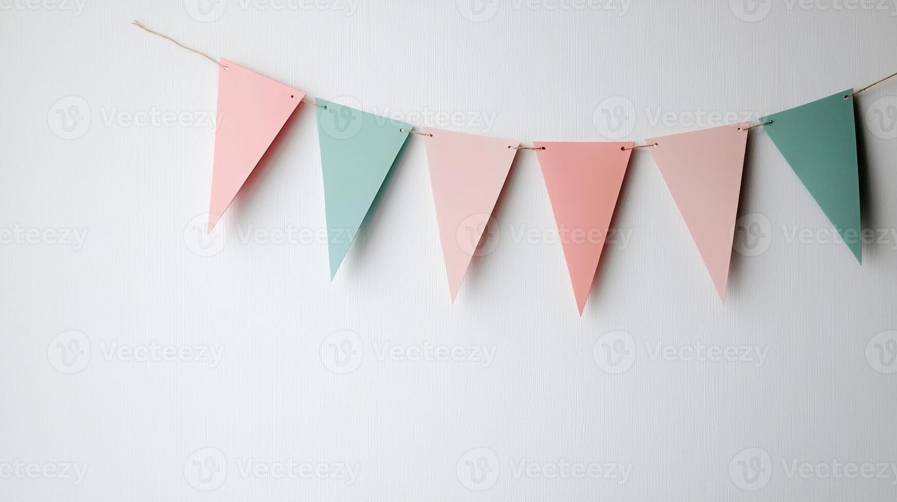 Colorful Party Bunting Flags Hanging on a String Against a White Background for Celebrations and Events photo