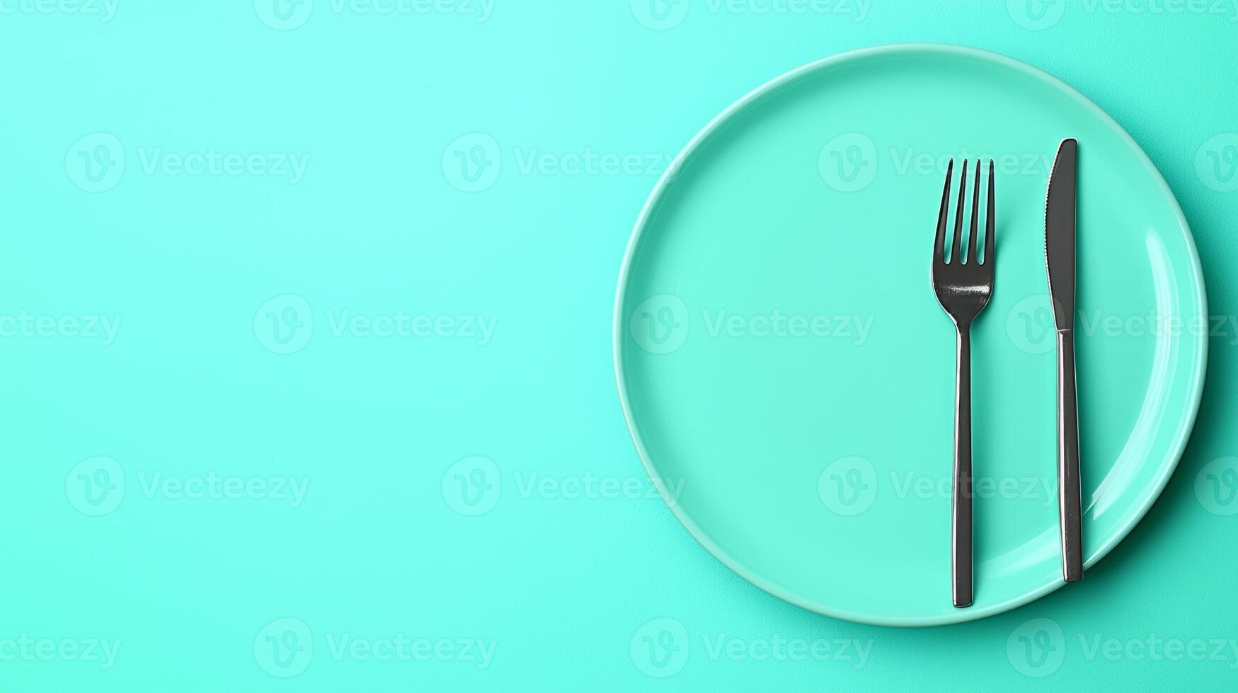 Elegant Dinner Concept with Minimalist Plate, Fork, and Knife on a Vibrant Turquoise Background photo