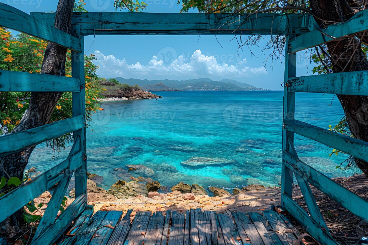 Tranquil Caribbean Seaside View Through Wooden Fence Framing Stunning Turquoise Ocean photo