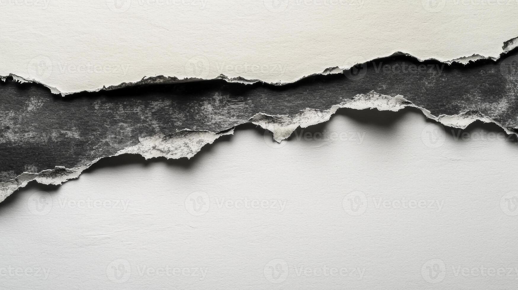 rip in a sheet of paper exposes a contrasting dark surface underneath featuring intricate highly detailed torn edges that create an artistic backdrop. photo