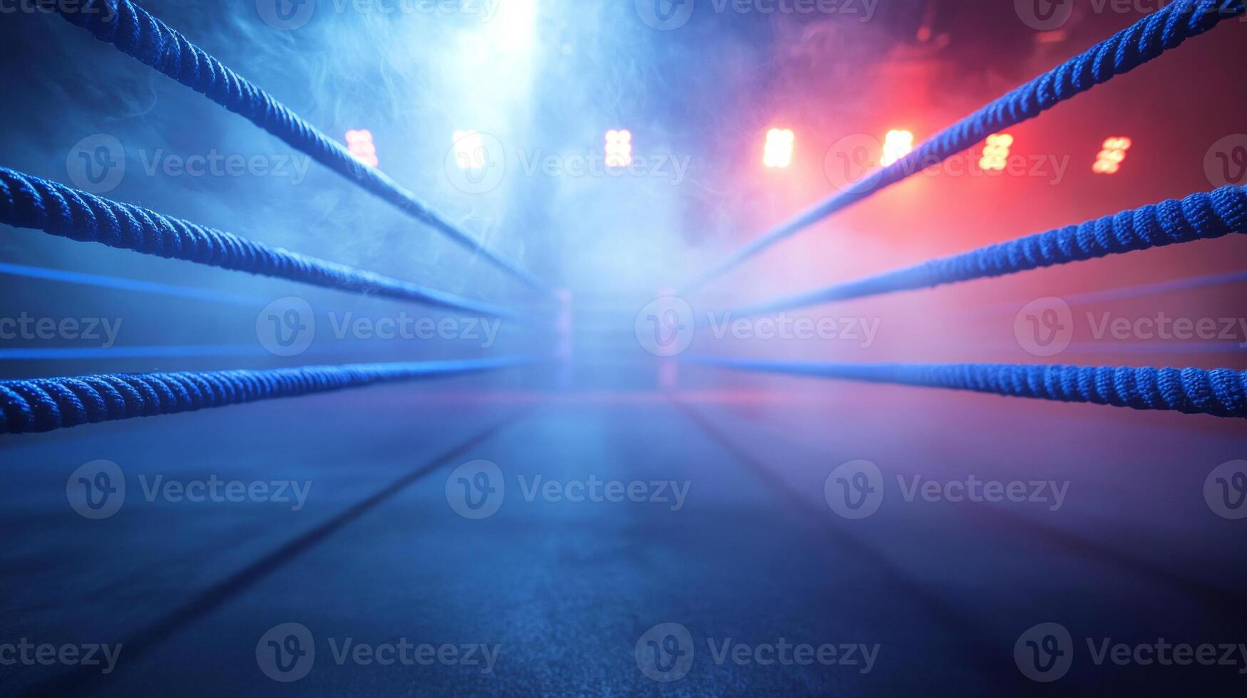 shot captures blue production ropes of a boxing ring set in a foggy environment with striking red and blue lighting creating an electrifying ambiance. photo