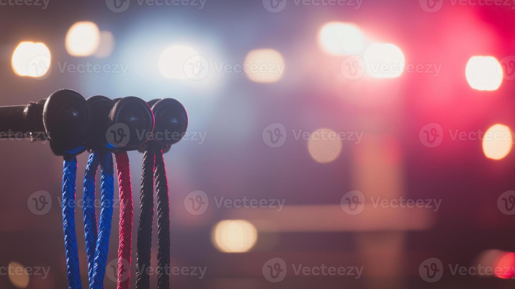 vibrant ropes hang in front of bright lights setting the stage for an electrifying wrestling match in the arena captivating the audiences attention. photo