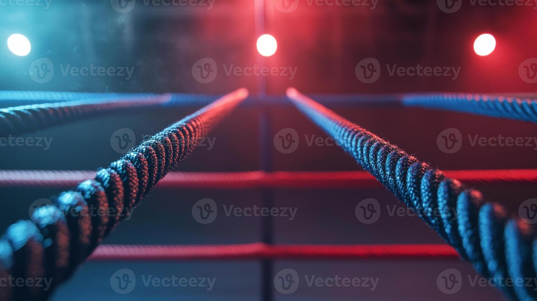 boxing ring showcases three parallel ropes vividly lit in red and blue creating an electrifying atmosphere for an exciting match or event. photo