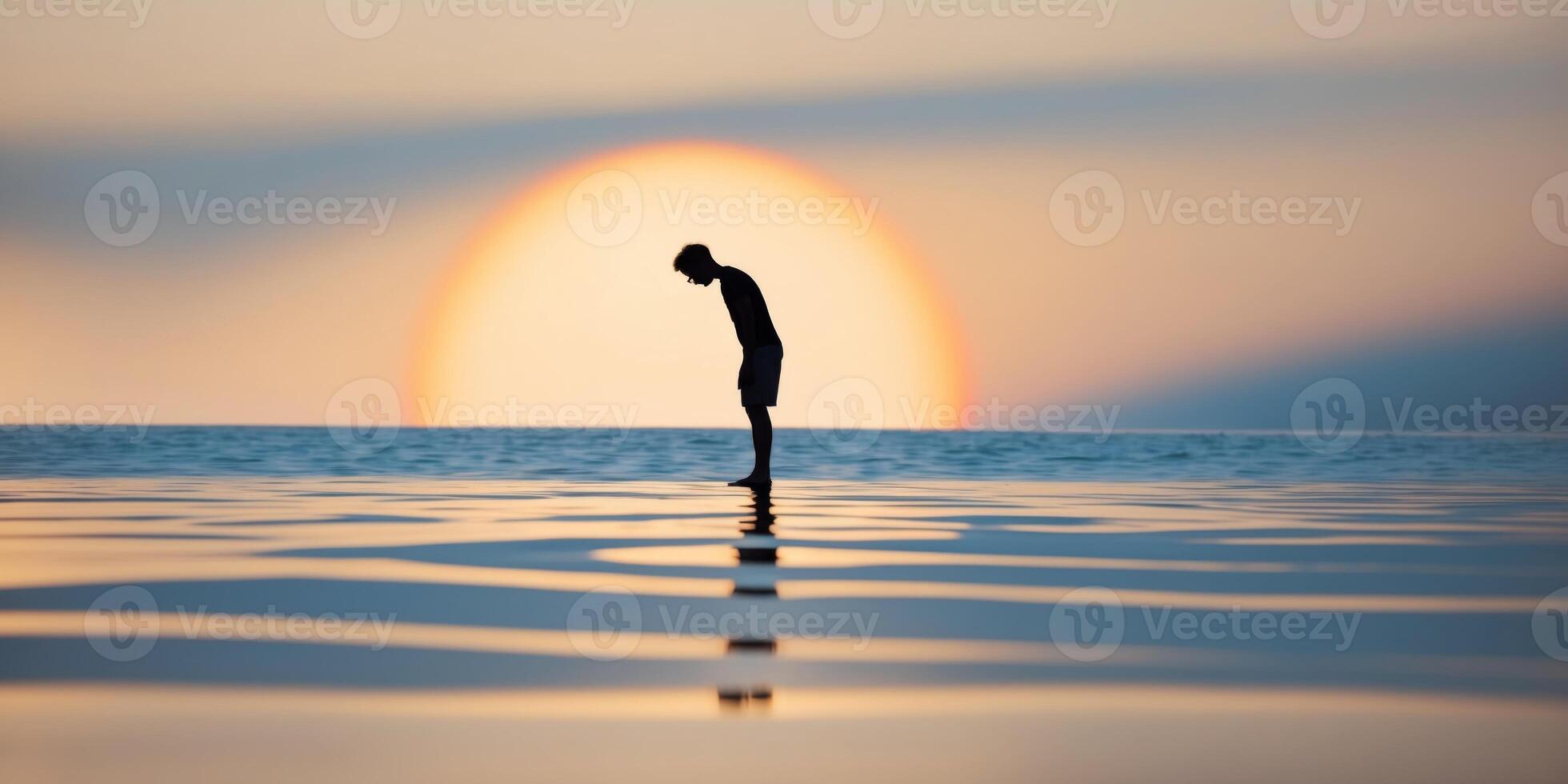 A man standing on a beach with his arms outstretched photo