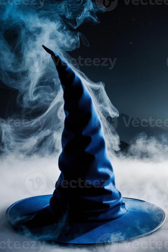 Blue mist surrounds a magical witch's hat in the night. photo