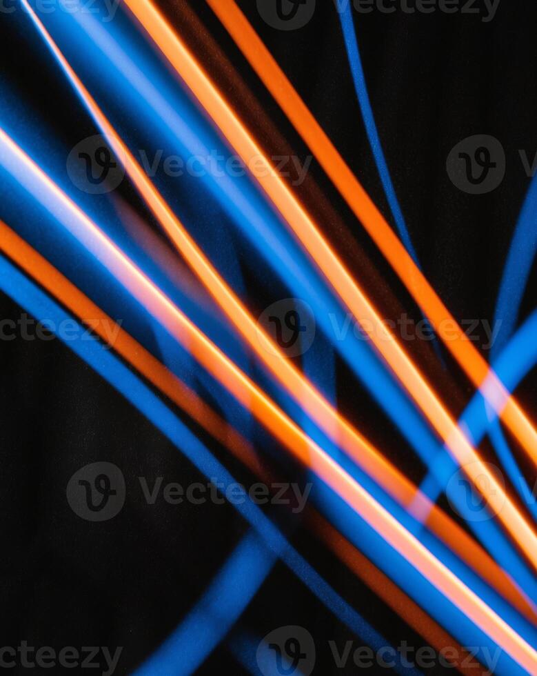 A blue and orange light line on a black background photo