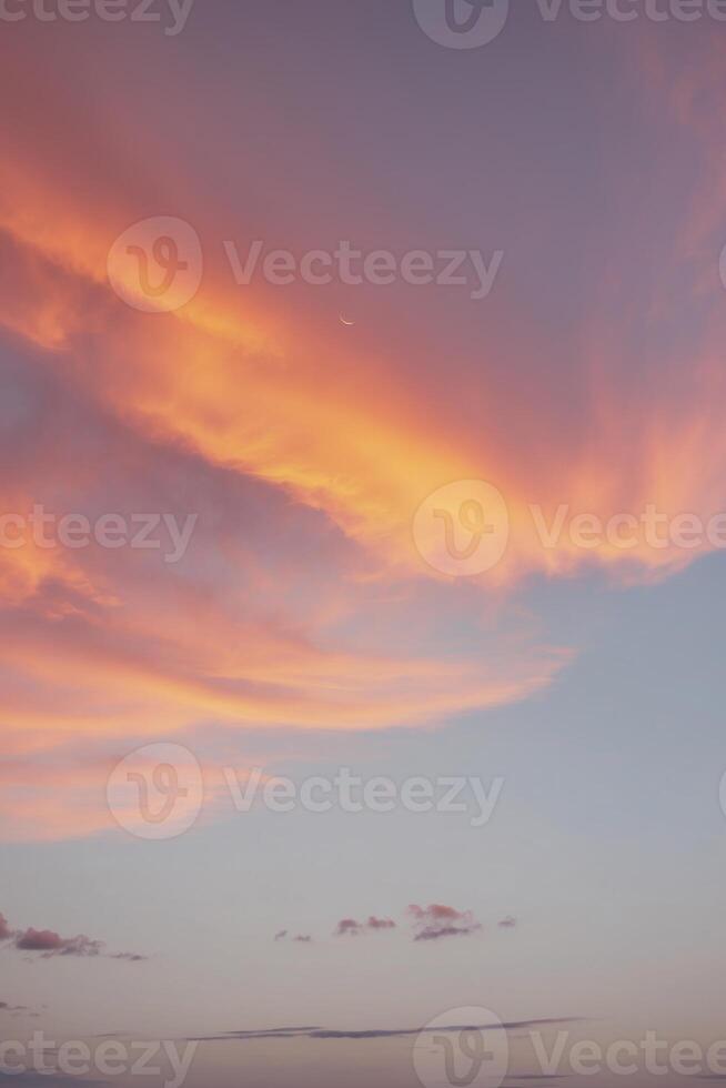 A sunset sky with clouds and a plane flying in the sky photo