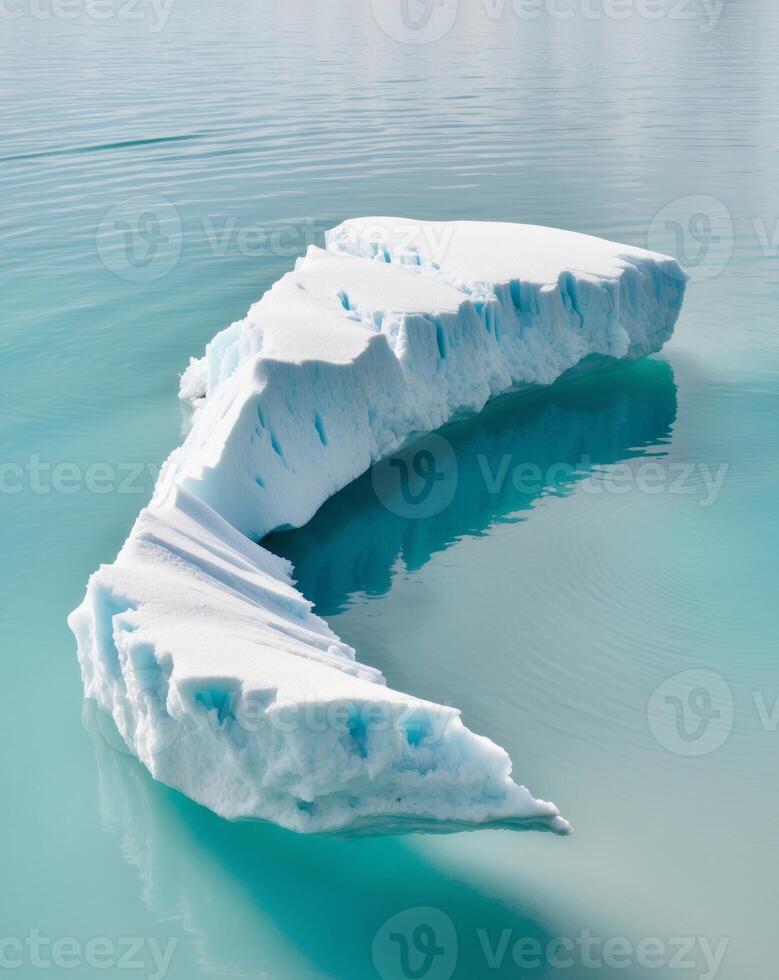 Icy glacier floating on serene blue waters. photo