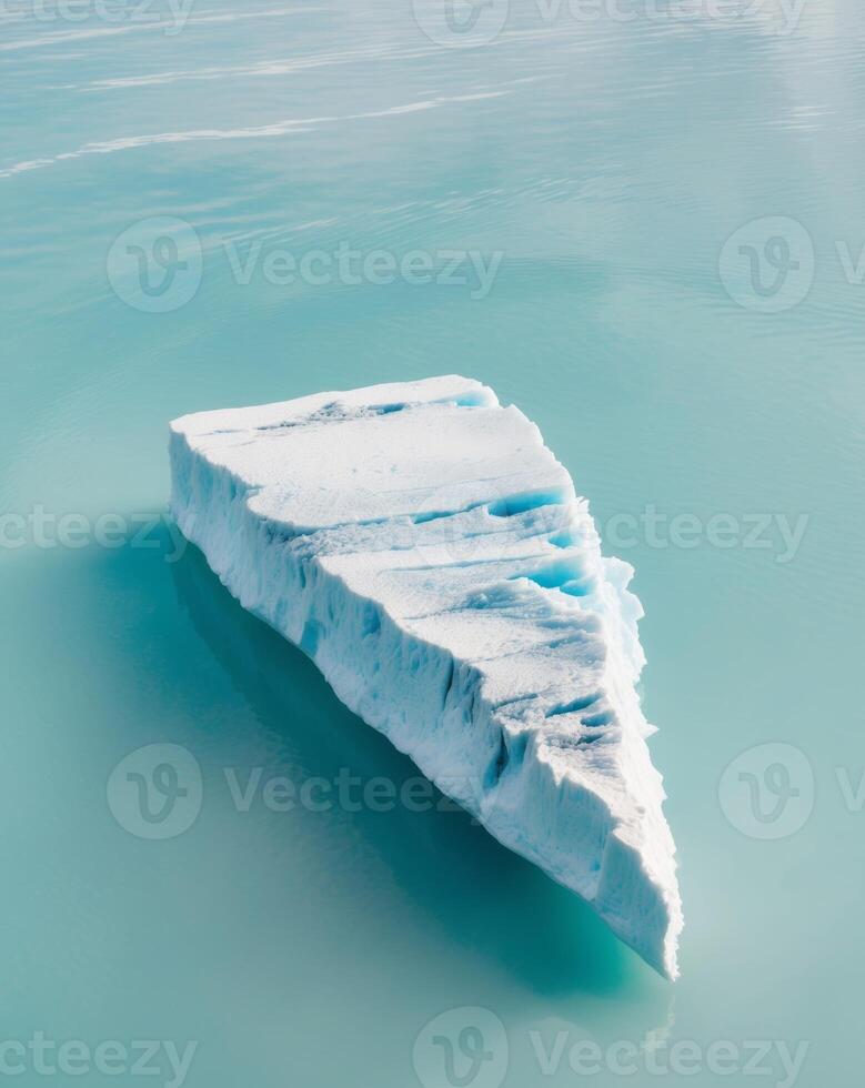 Icy glacier floating on serene blue waters. photo