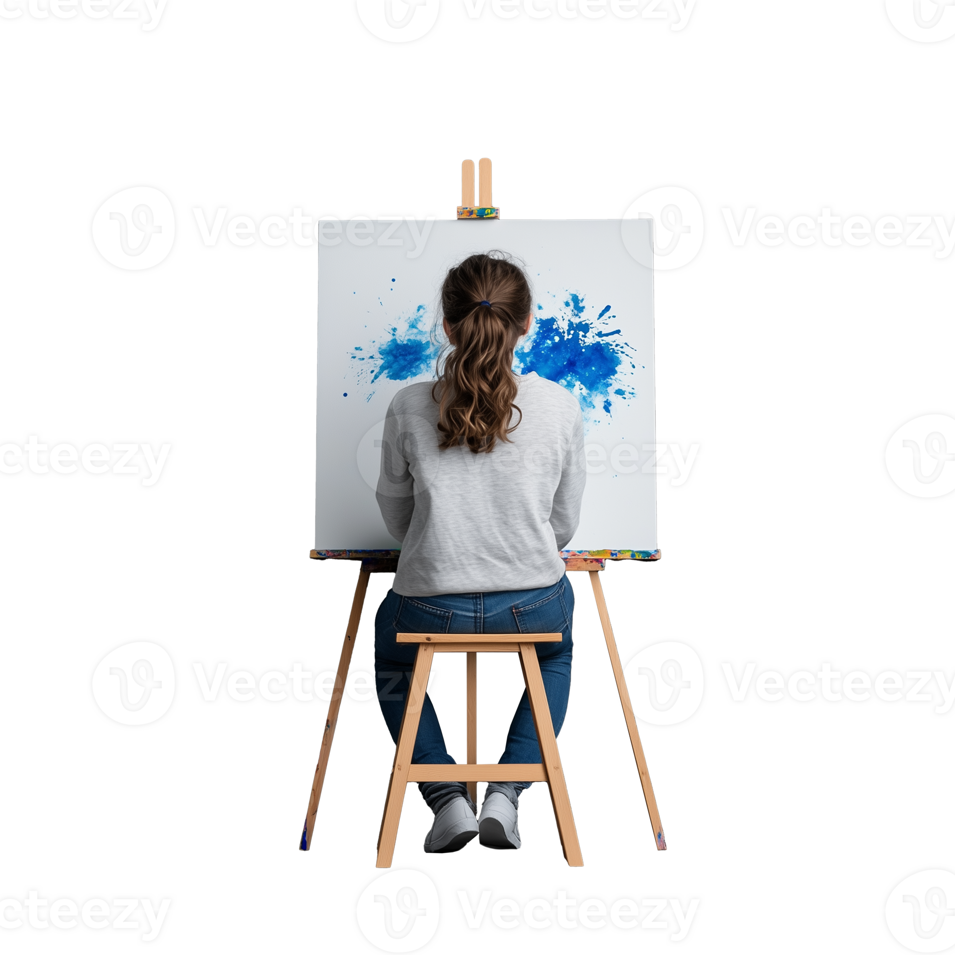 Girl painting on a canvas with blue paint, sitting on a wooden stool