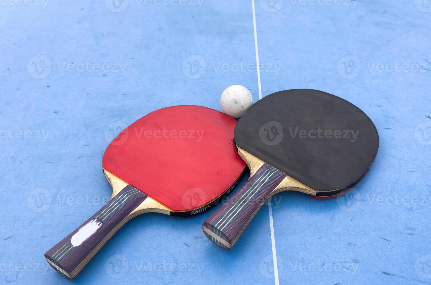 Table tennis. Blue ping pong table. Ping pong rackets and ball. The concept of sport and healthy lifestyle. photo