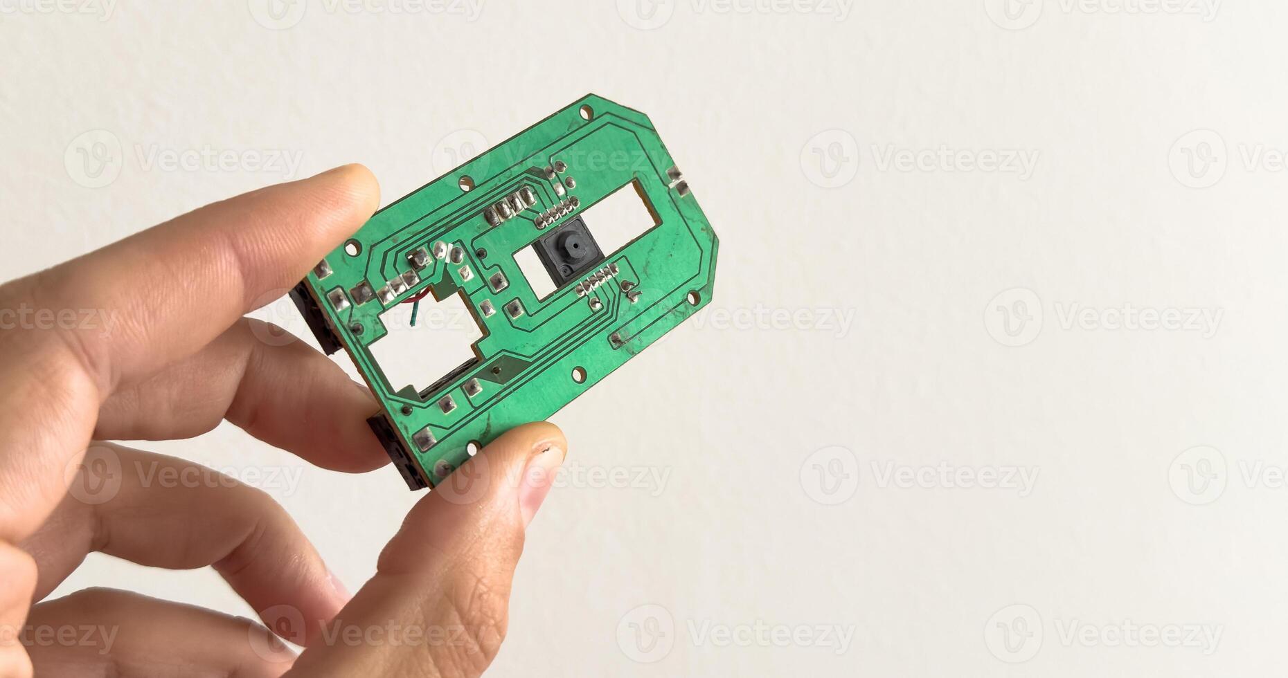 Man holding up a RAM module, or random access memory, in which all storage locations can be rapidly accessed in the same amount of time used by a computer operating system, on white photo