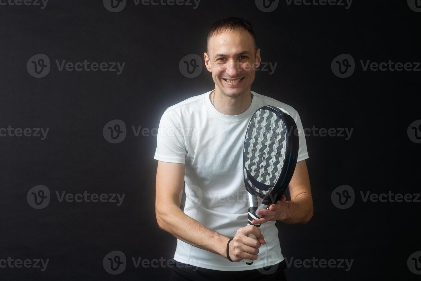 Padel Tennis Player with Racket in Hand. Paddle tennis, on a black background. photo