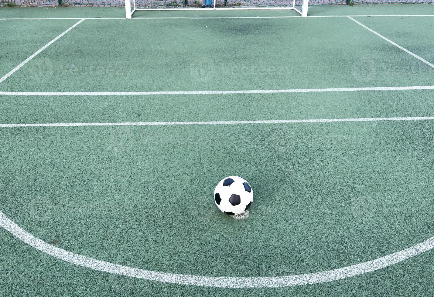 The ball in grass. The sideline. Fresh green grass. Black and white ball. photo