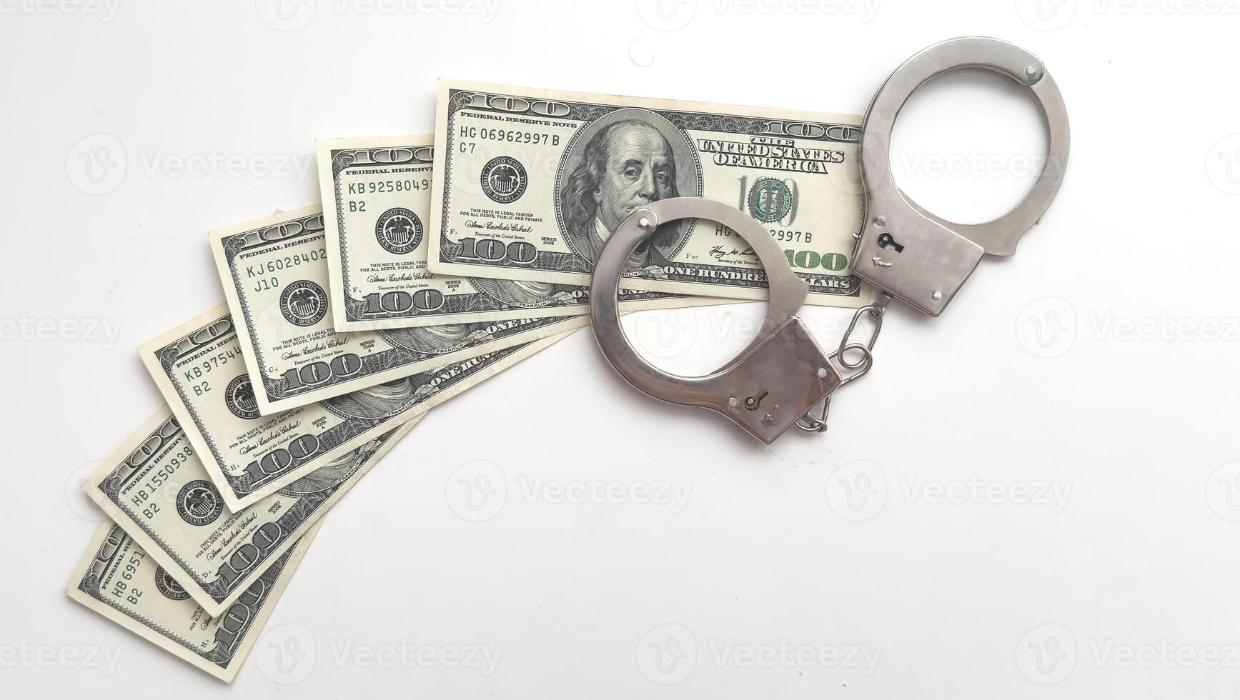 Dollars of hundred and fifty dollars lie on a floor and from above handcuffs for detention of the corrupt official on polichny are put. photo