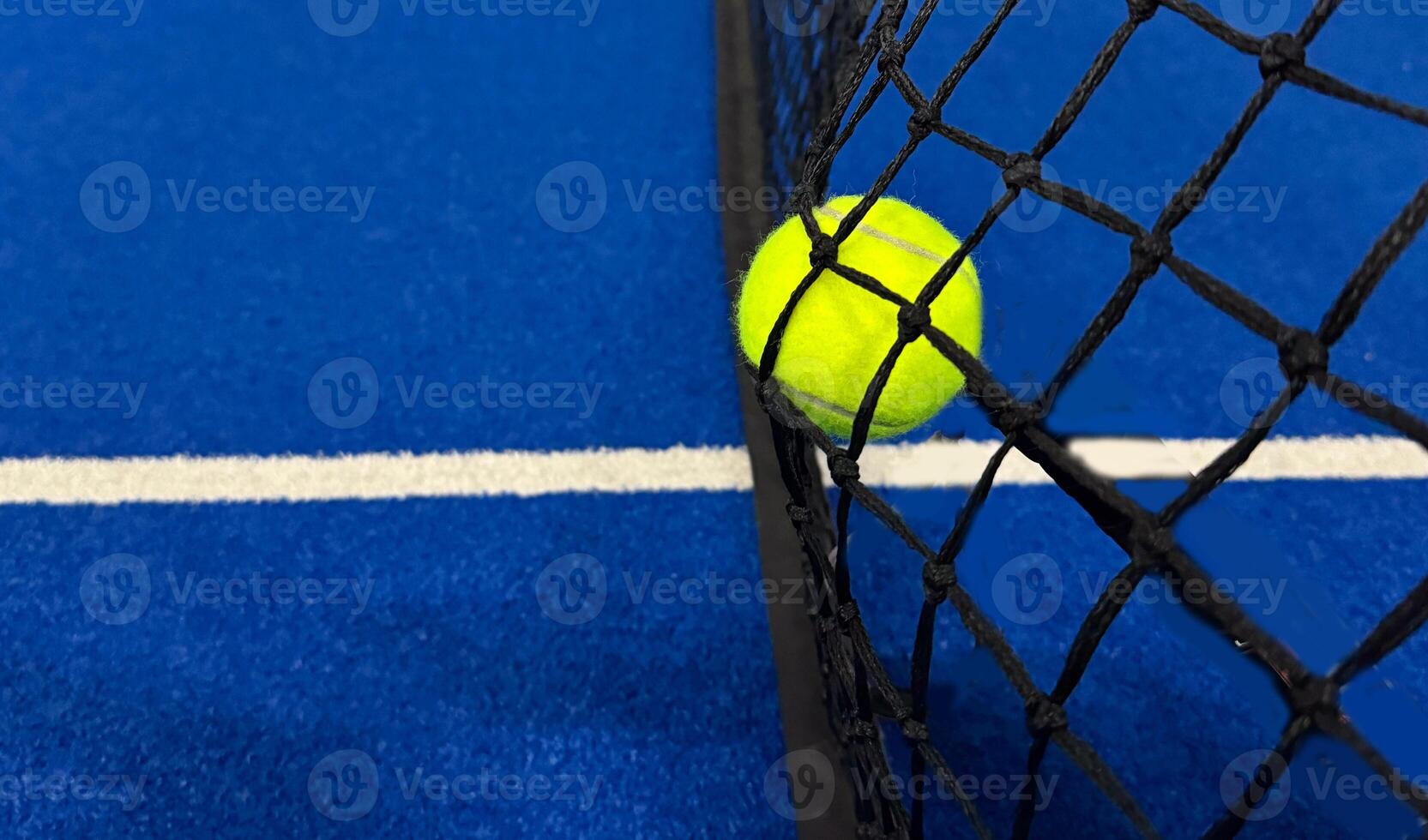 tennis balls in black net photo