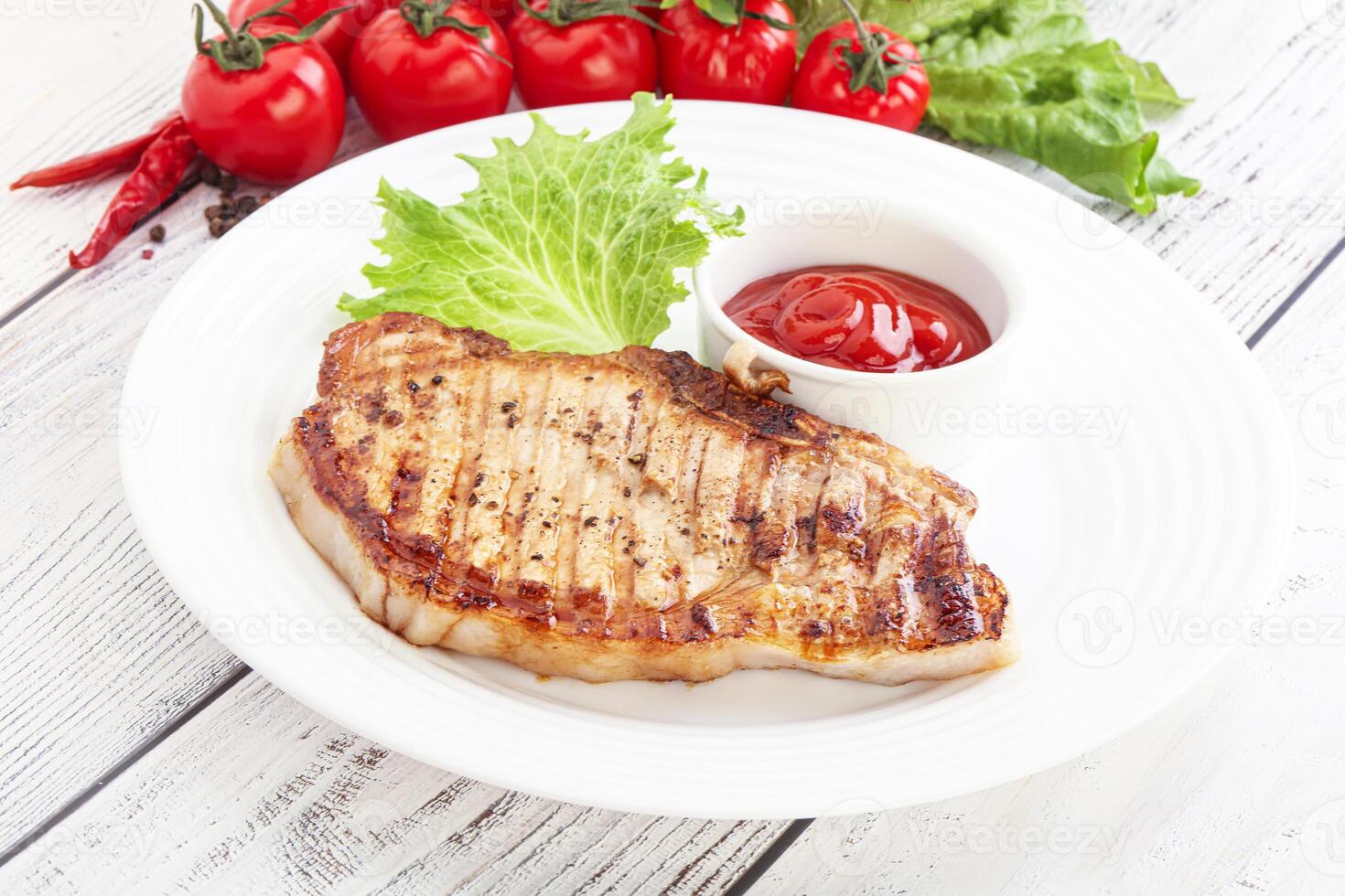 Grilled pork steak with ketchup photo