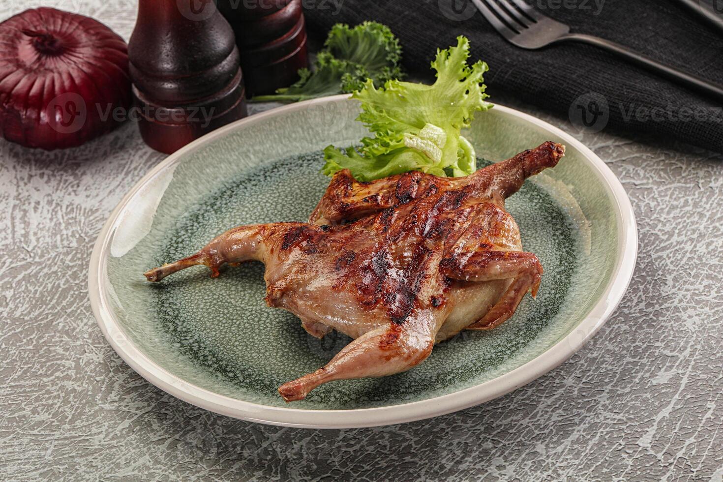 Grilled quail in the plate photo