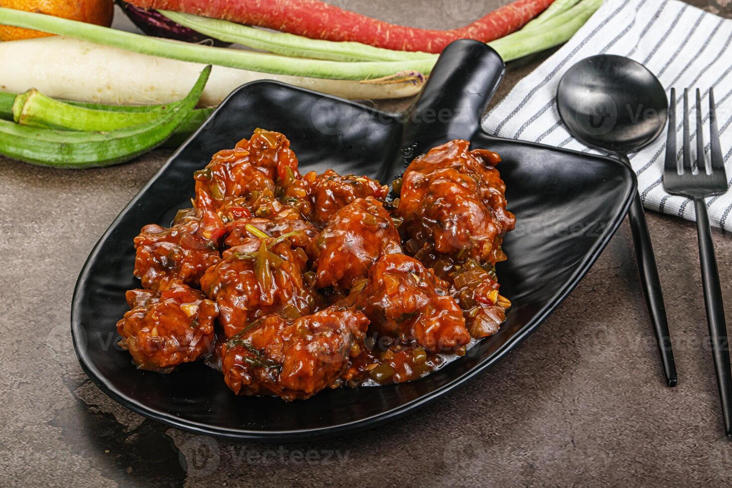 Manchurian chicken with sauce and spices photo
