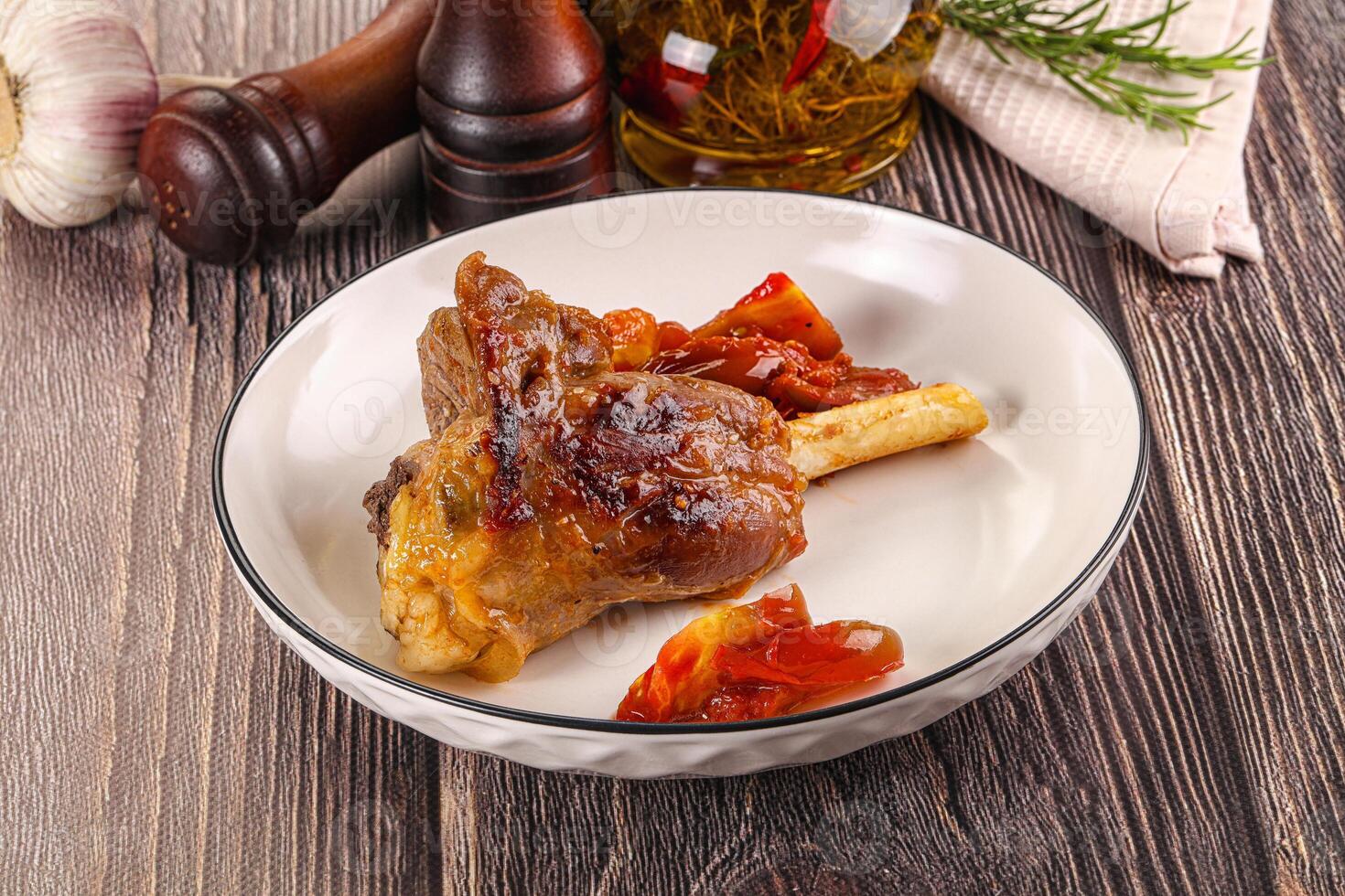 Baked lamb shank with vegetables photo