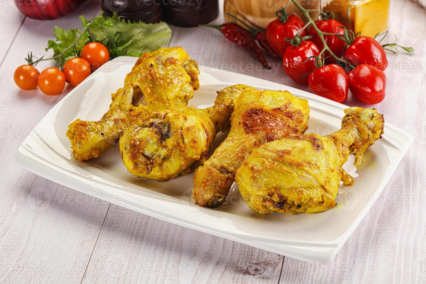 Roasted Chicken leg drumsticks with curry sauce photo