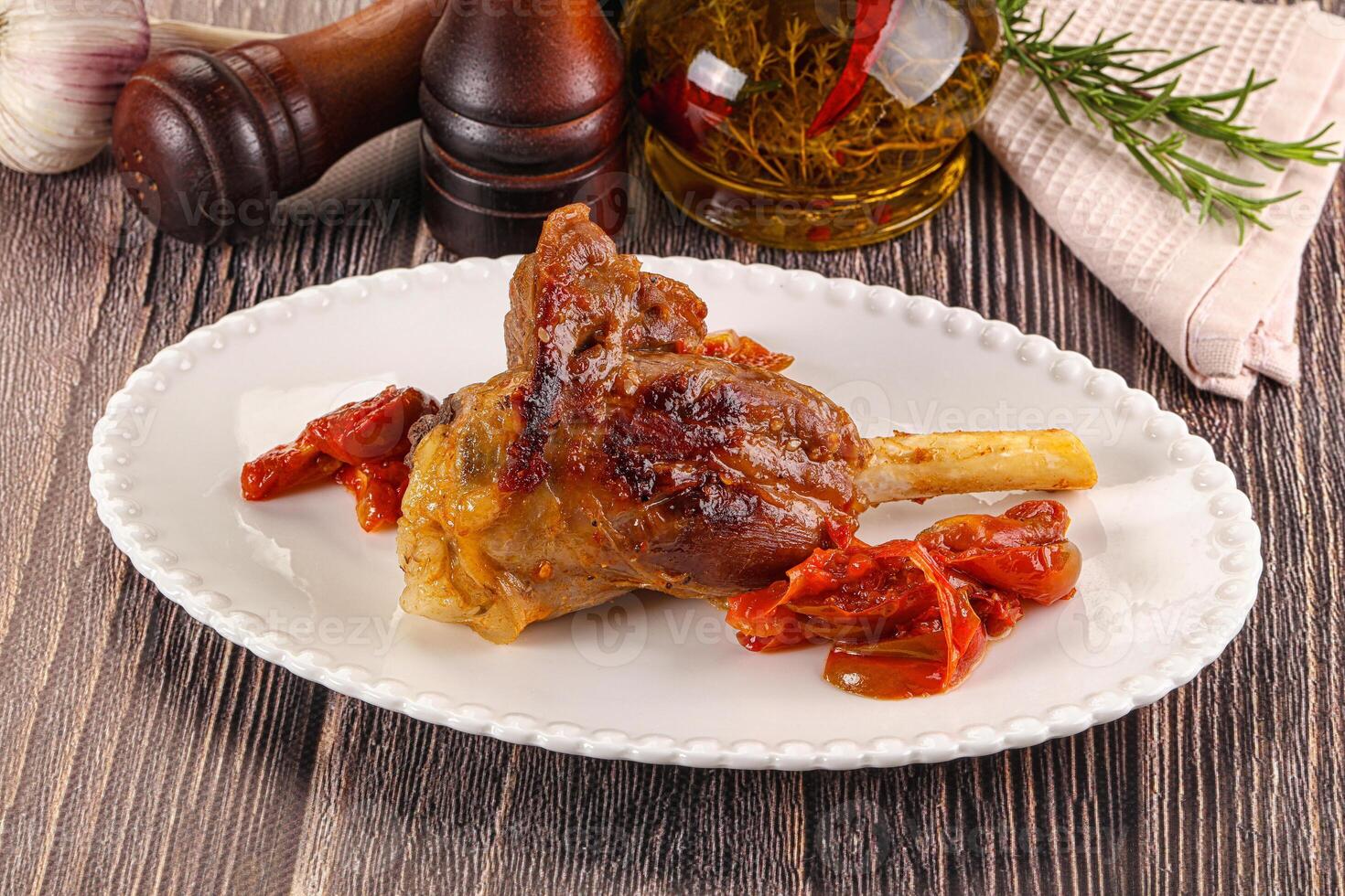 Baked lamb shank with vegetables photo