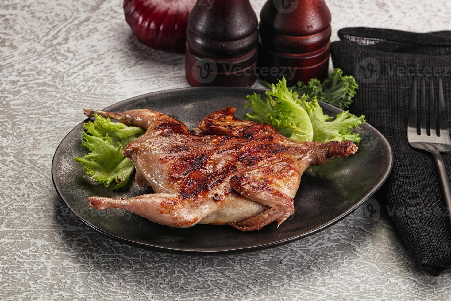 Grilled quail in the plate photo