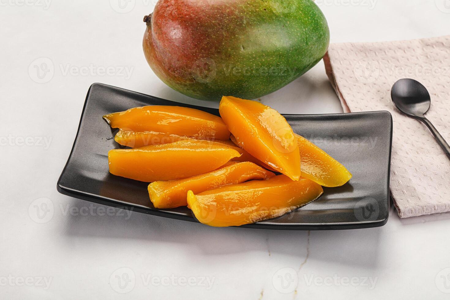 Canned mango slices in the bowl photo