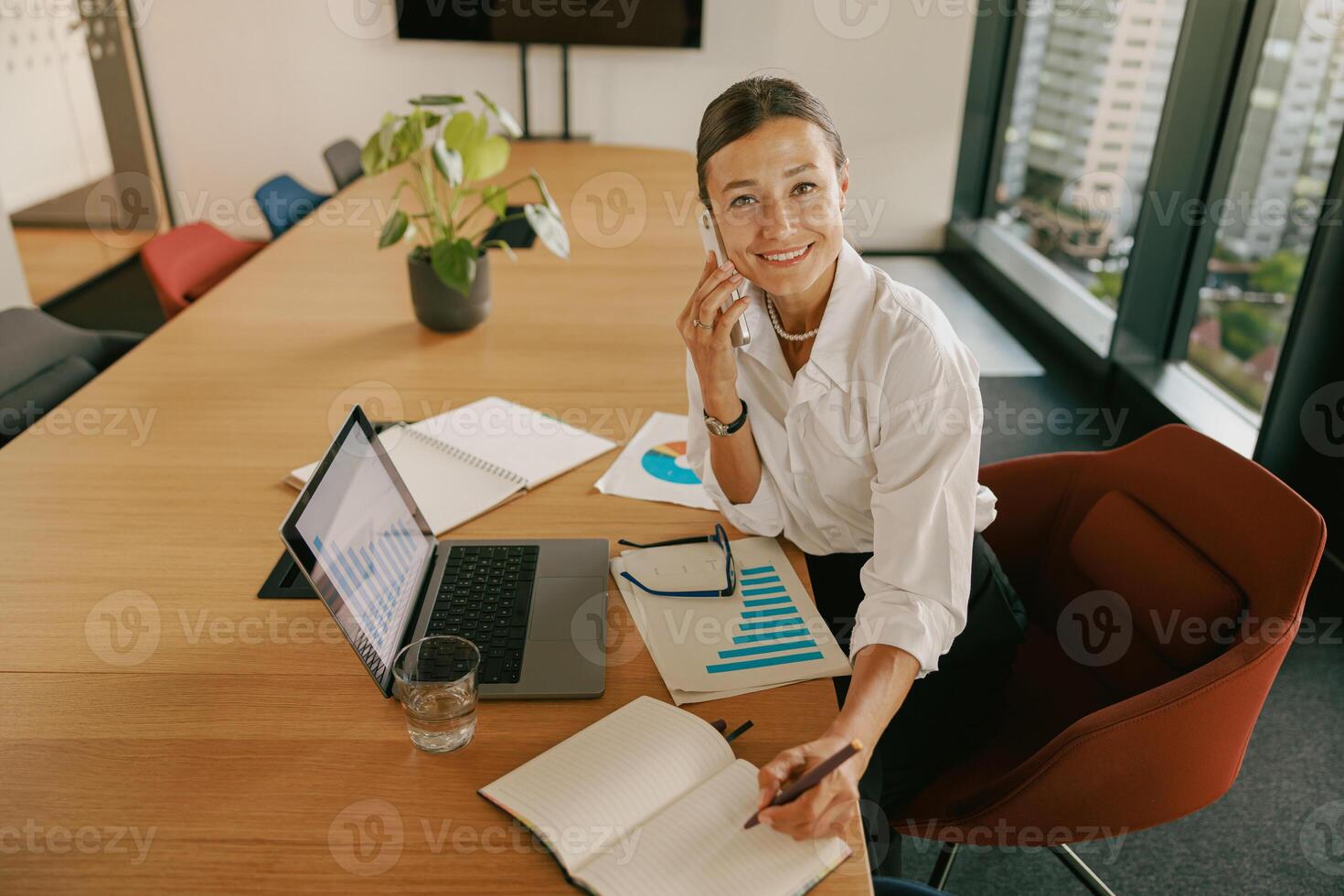 A Professional Woman Engaged in Tasks at Her Work in a Modern and Stylish Office Setting photo
