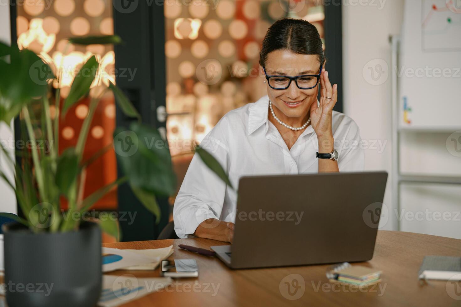 A Dedicated and Focused Professional Working Intently on a Laptop in a Modern Office Space photo