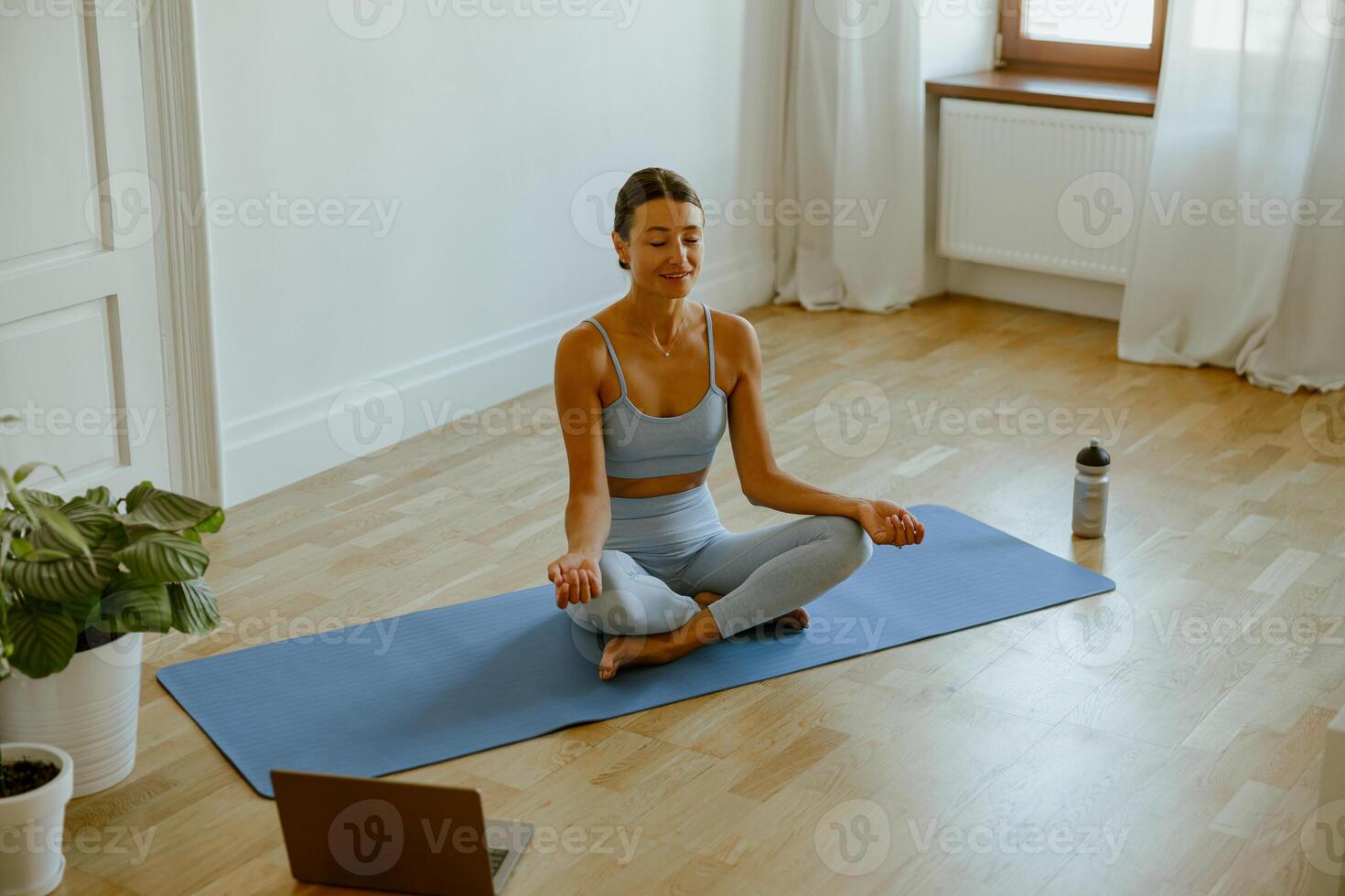 Engaging in a Relaxing Home Yoga Session, Embraced by a Serene and Peaceful Space photo