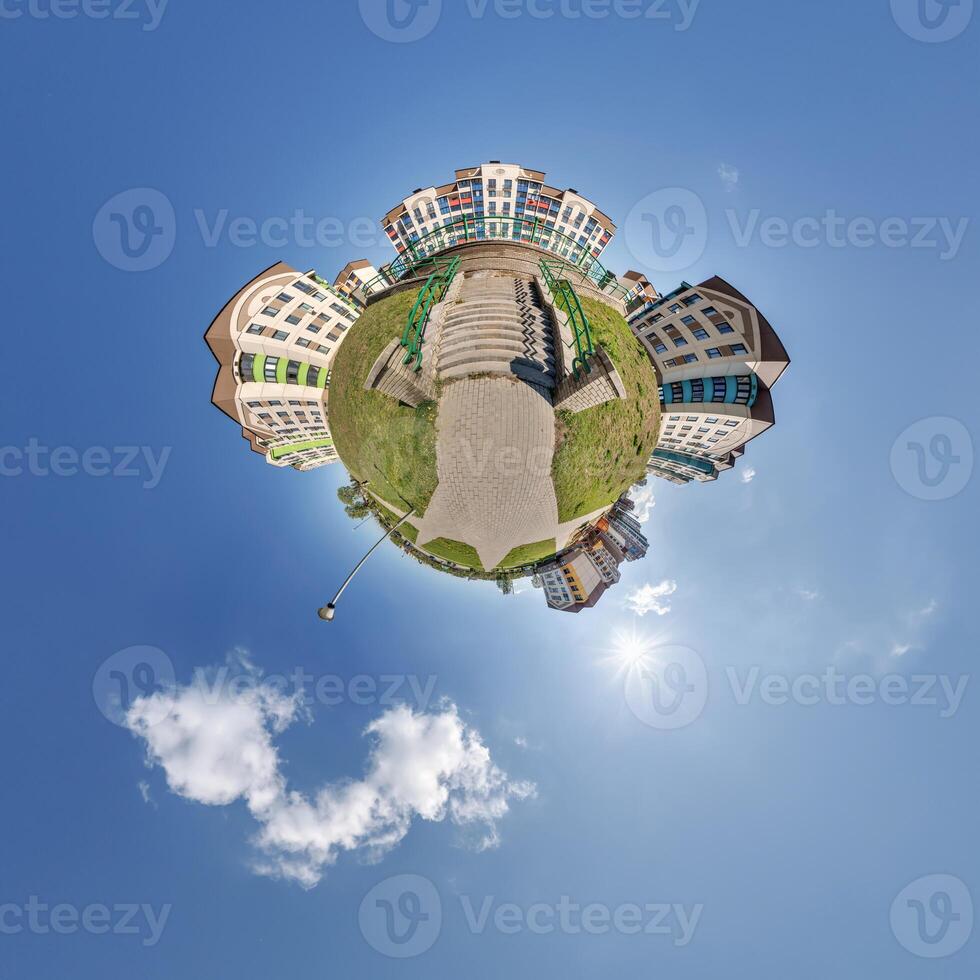 modern low-rise residential townhouse on surface of little tiny planet in blue sky with sun. Transformation of spherical panorama 360 degrees. Spherical abstract aerial view. Curvature of space. photo