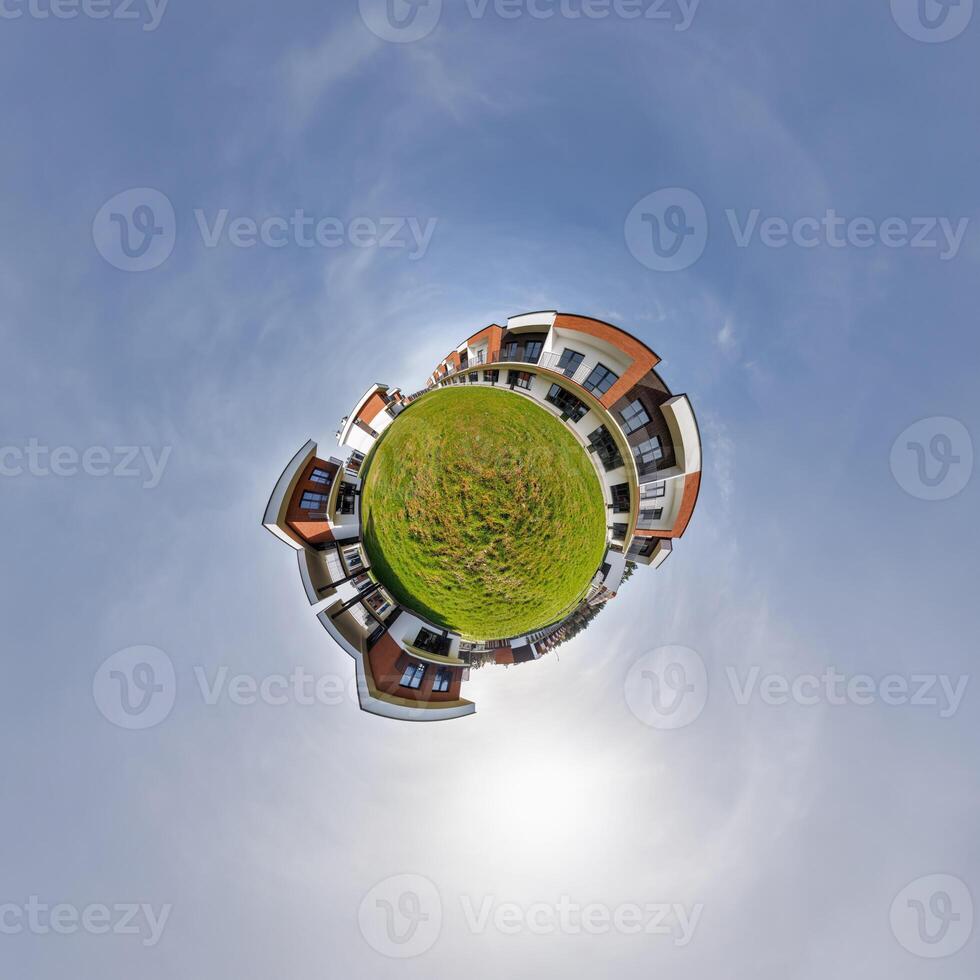 modern low-rise residential townhouse on surface of little tiny planet in blue sky with sun. Transformation of spherical panorama 360 degrees. Spherical abstract aerial view. Curvature of space. photo