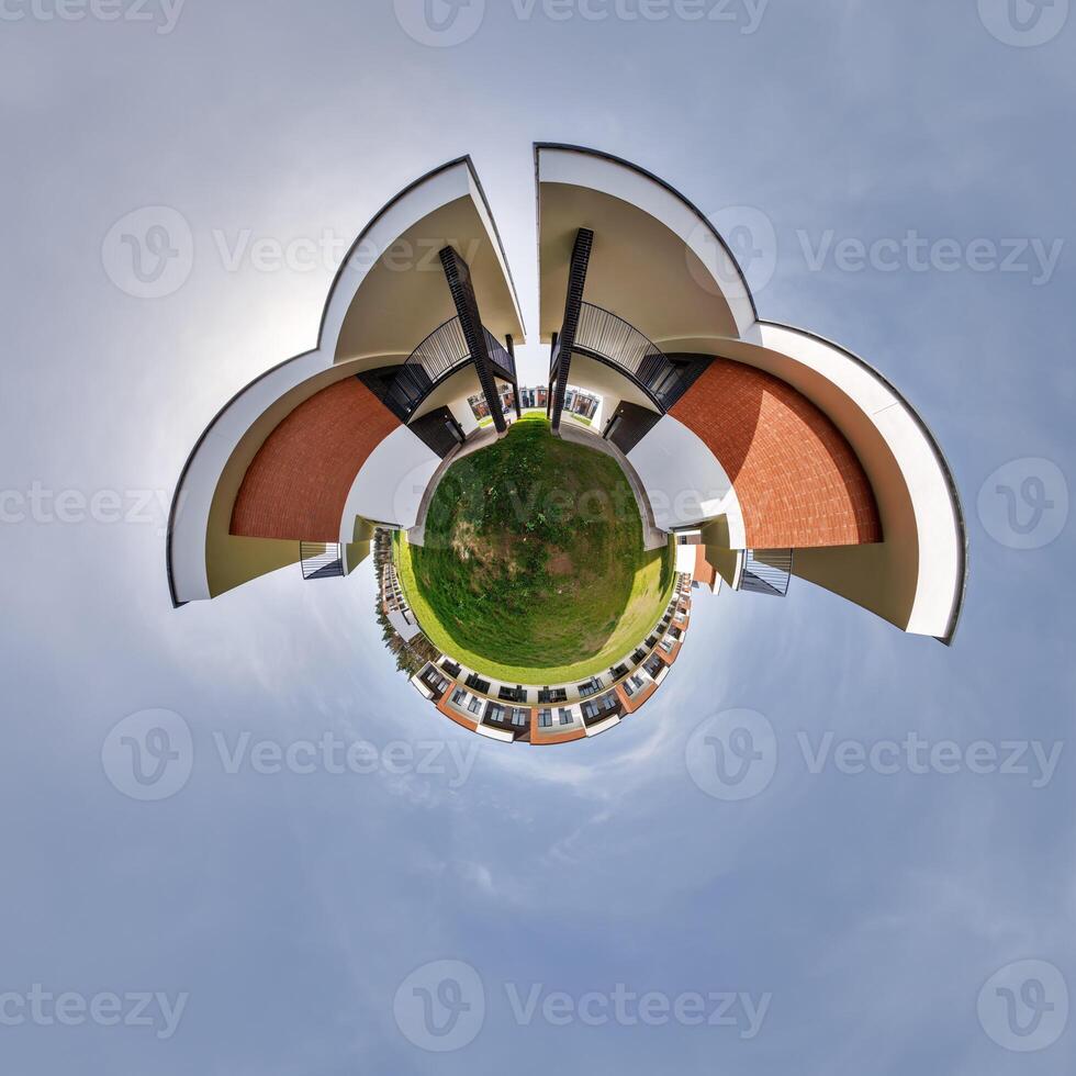 modern low-rise residential townhouse on surface of little tiny planet in blue sky with sun. Transformation of spherical panorama 360 degrees. Spherical abstract aerial view. Curvature of space. photo
