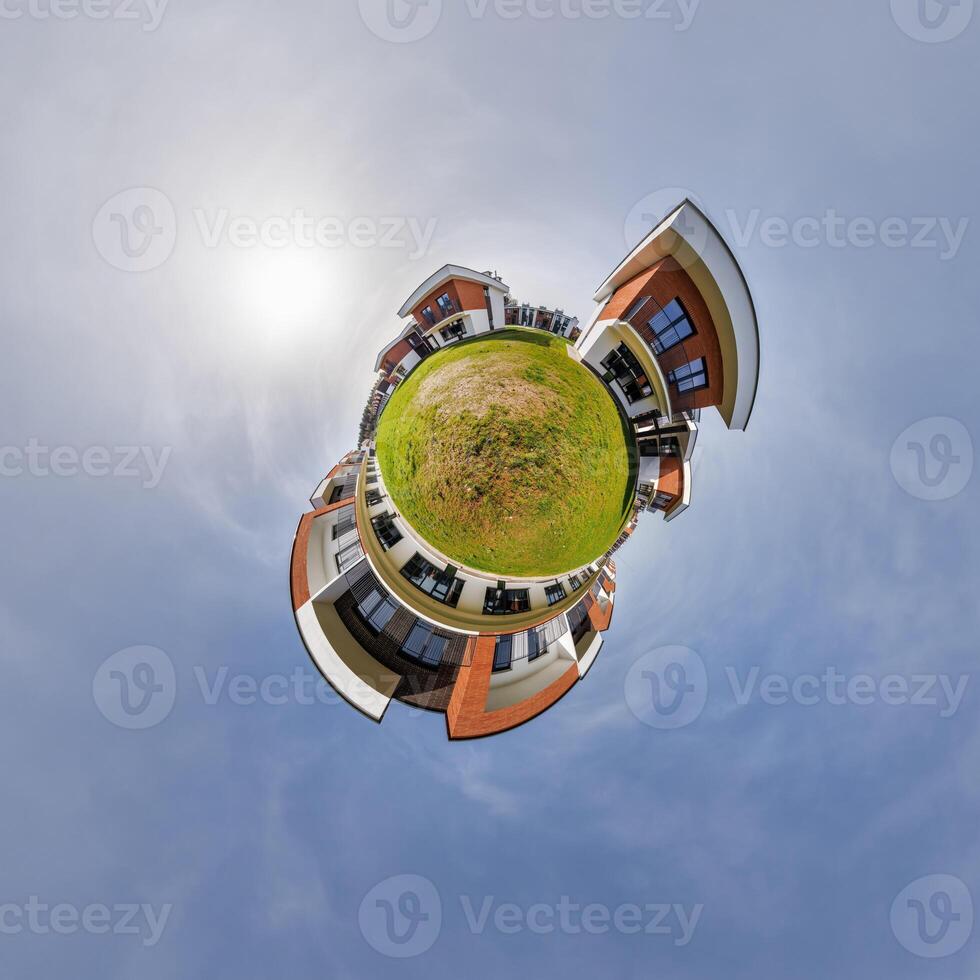 modern low-rise residential townhouse on surface of little tiny planet in blue sky with sun. Transformation of spherical panorama 360 degrees. Spherical abstract aerial view. Curvature of space. photo