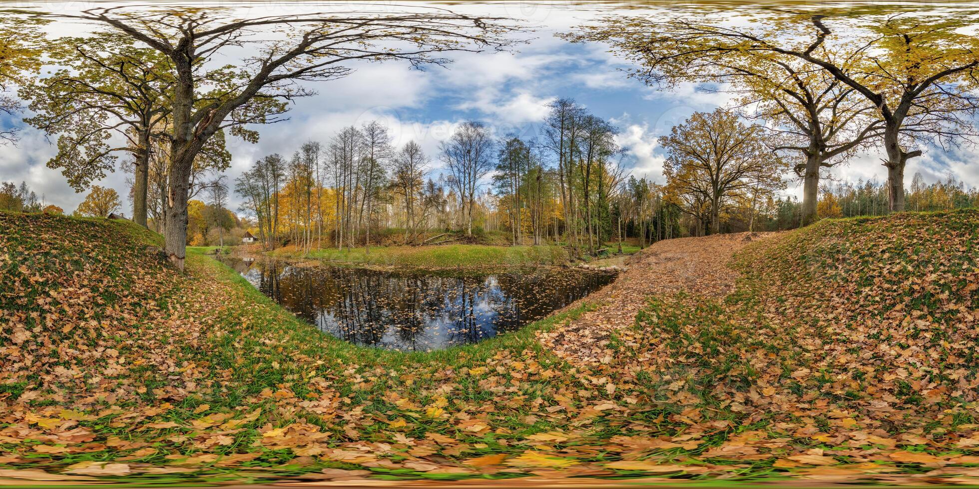 seamless spherical 360 hdri panorama in middle of oak forest near an abandoned pond or lake in golden autumn in equirectangular projection, ready VR AR virtual reality content photo