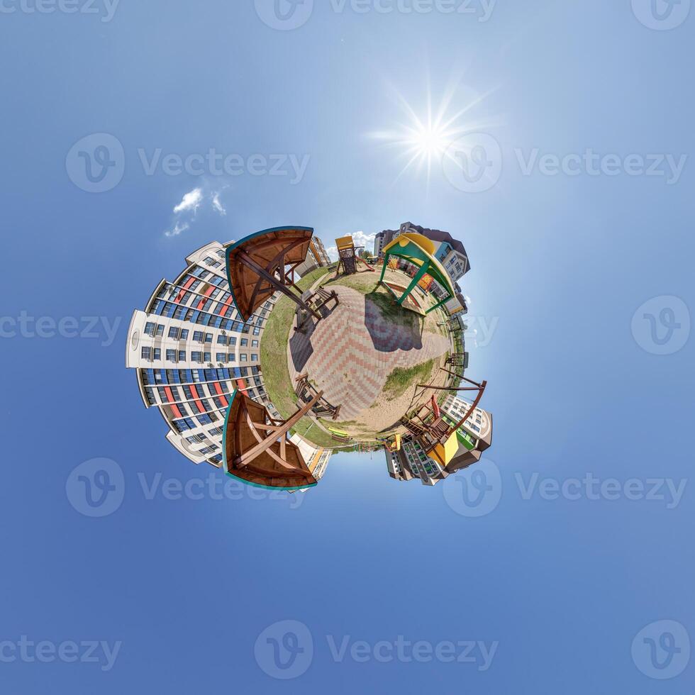 modern low-rise residential townhouse on surface of little tiny planet in blue sky with sun. Transformation of spherical panorama 360 degrees. Spherical abstract aerial view. Curvature of space. photo