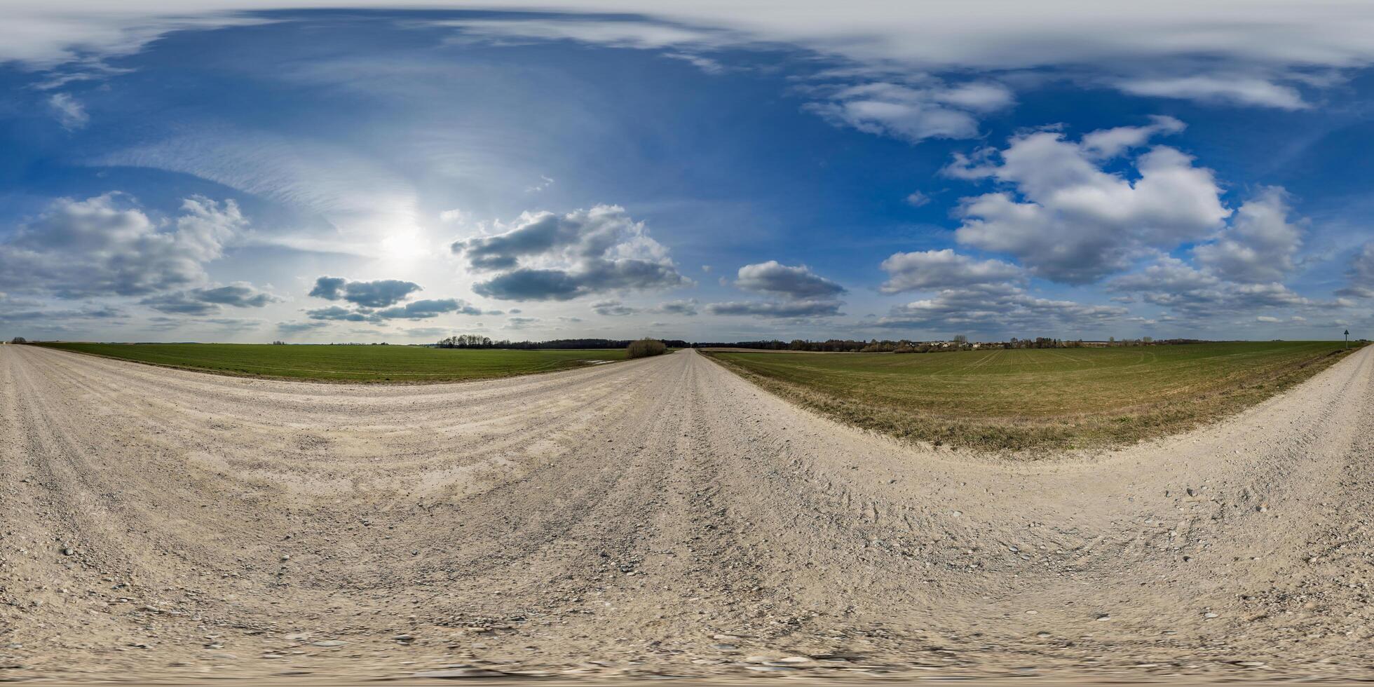 spherical 360 hdri panorama on roadside of gravel road with clear clouds in thunderstorm front dark sky in equirectangular seamless projection, as skydome replacement in drone panoramas photo