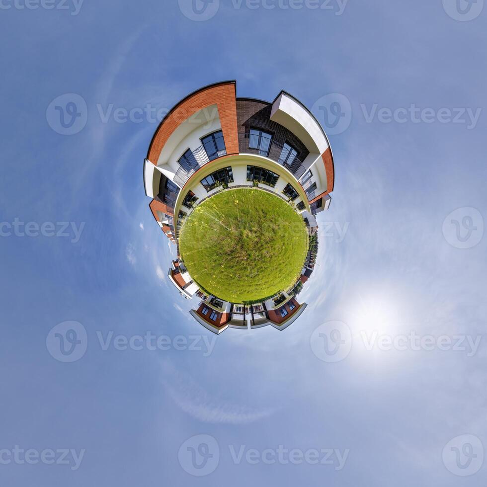 modern low-rise residential townhouse on surface of little tiny planet in blue sky with sun. Transformation of spherical panorama 360 degrees. Spherical abstract aerial view. Curvature of space. photo