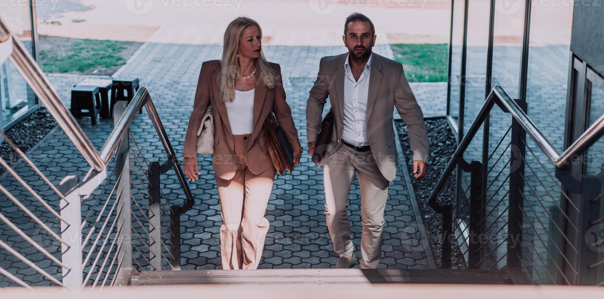 Modern business couple after a long day's work, walking together towards the comfort of their home, embodying the perfect blend of professional success and personal contentment. photo
