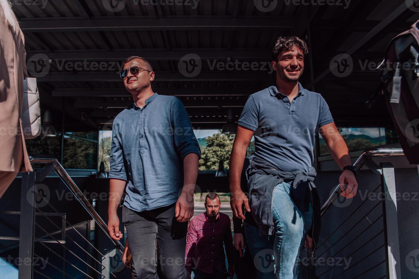 A diverse group of businessmen and colleagues walking together by their workplace, showcasing collaboration and teamwork in the company. photo