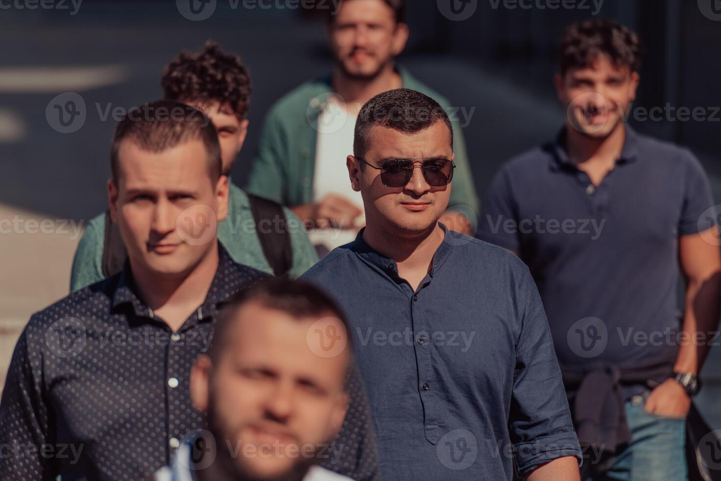 A diverse group of businessmen and colleagues walking together by their workplace, showcasing collaboration and teamwork in the company. photo