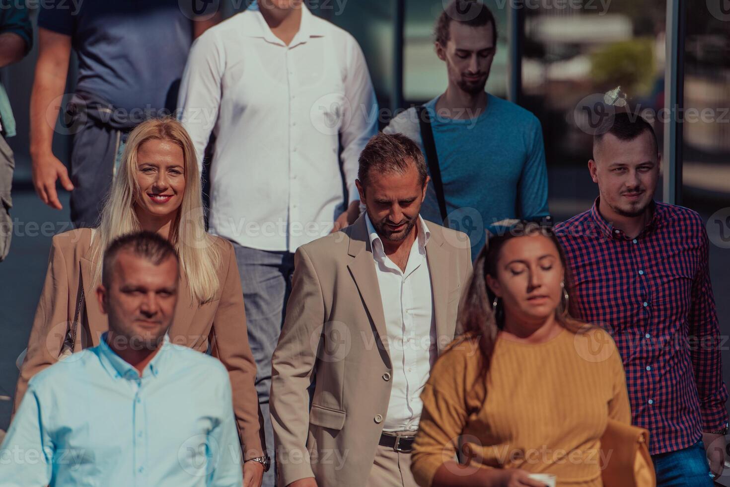 A diverse group of businessmen and colleagues walking together by their workplace, showcasing collaboration and teamwork in the company. photo