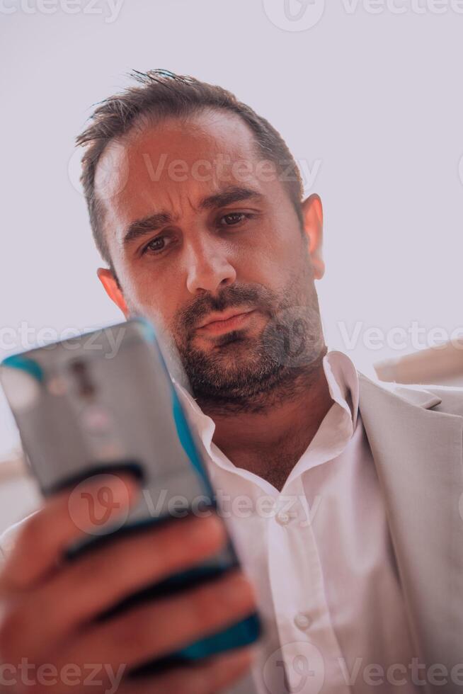 A businessman using his smartphone outdoors, showcasing the seamless integration of technology and mobility in modern professional life. photo