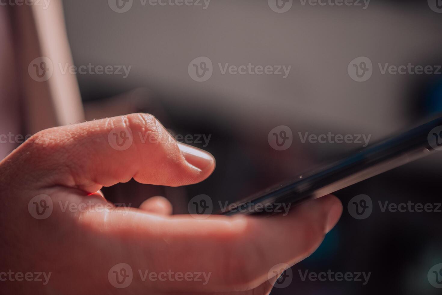 Closeup photo of businessman hand utilizes his smartphone outdoors, showcasing the seamless integration of technology and mobility in modern professional life.