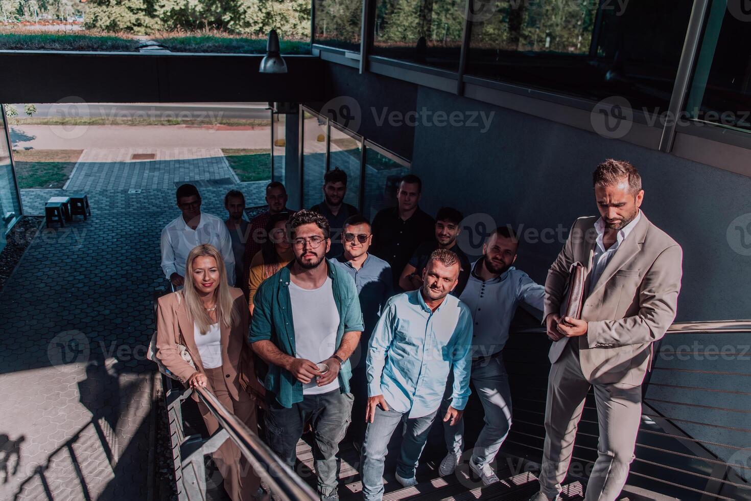 A diverse group of businessmen and colleagues walking together by their workplace, showcasing collaboration and teamwork in the company. photo