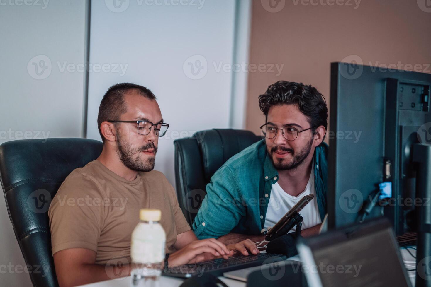 Programmers engrossed in deep collaboration, diligently working together to solve complex problems and develop innovative mobile applications with seamless functionality. photo